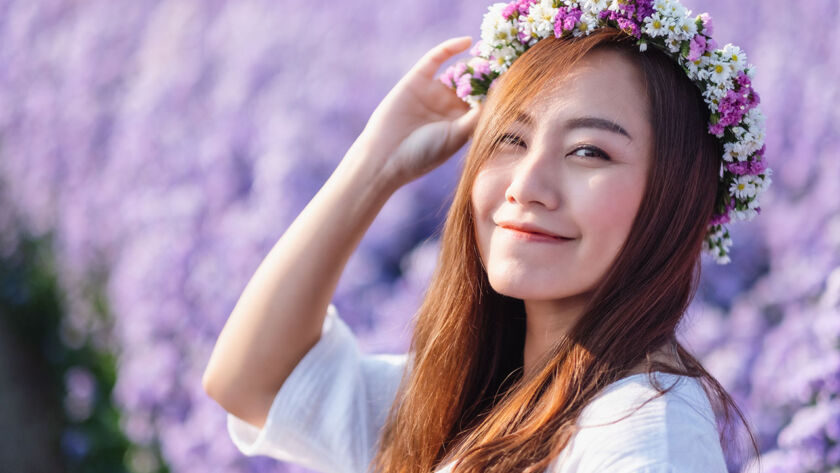 Portrait image of an asian woman in a beautiful Margaret flower field image