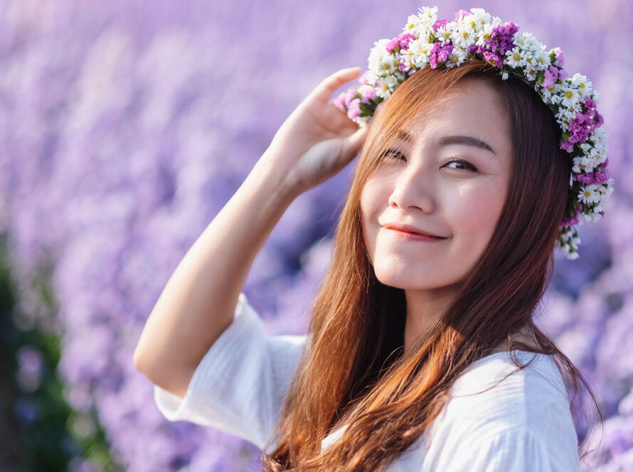 Portrait image of an asian woman in a beautiful Margaret flower field image